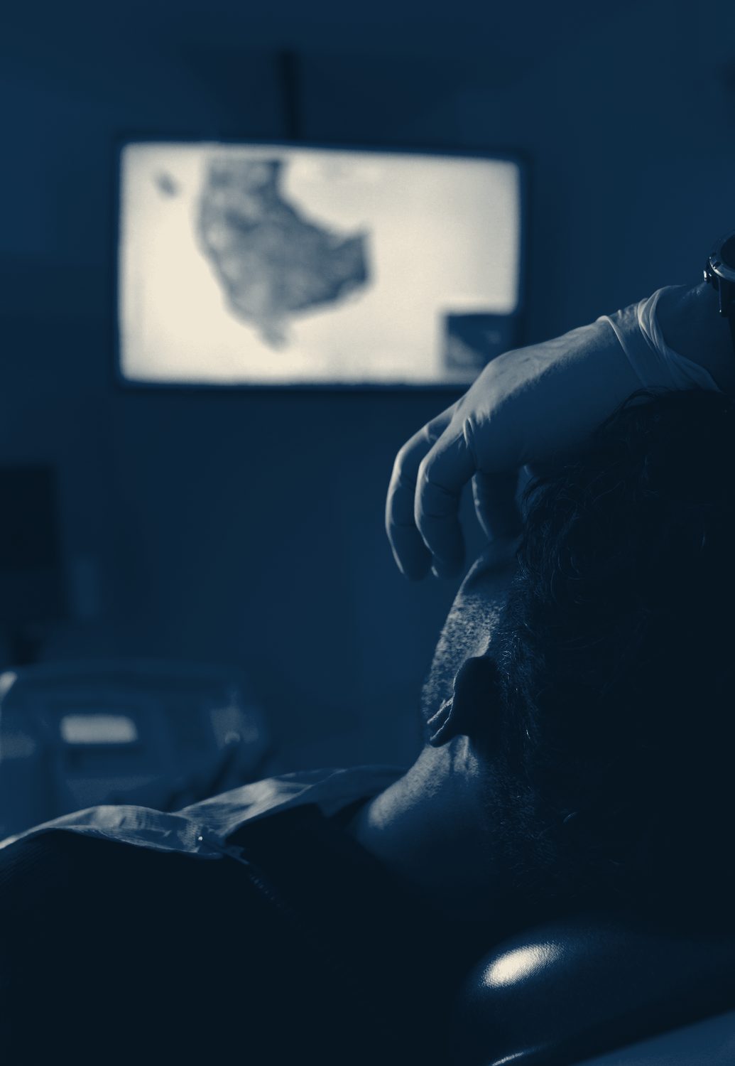 A patient reviewing on-screen dental imaging during treatment planning